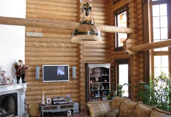 This interior of a wooden house made of logs combines modernity and classics, inside it is cozy and comfortable