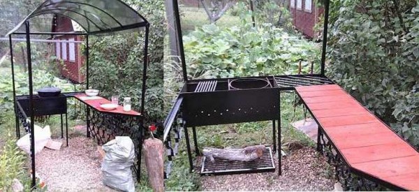 Homemade barbecue under a canopy with a kitchenette