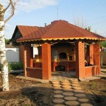 Powerful columns with half-brick railing between them. If necessary, this summer gazebo can be easily converted into a winter one: put double-glazed windows or wooden frames