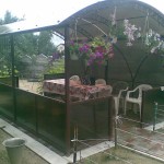 A simple solution for a summer residence: a square gazebo covered with beige polycarbonate