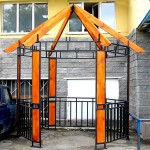 Photo of a hexagonal gazebo made of metal profile with partial wood trim