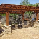 Summer open gazebo: on the stone pillars there are powerful stands made of timber