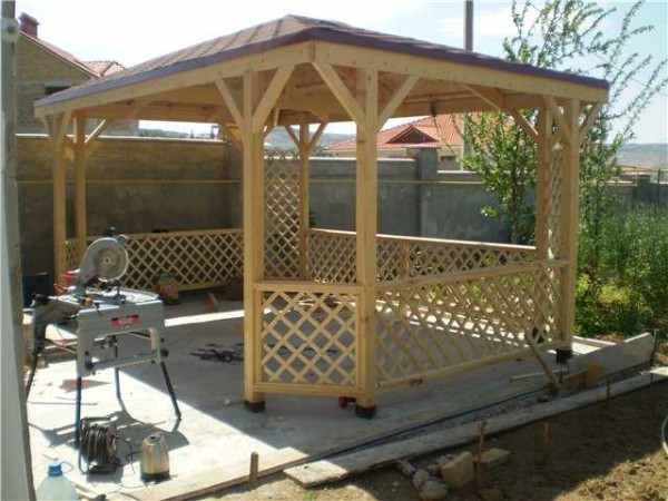 This is a wooden frame gazebo without a floor. Please note that the roof is quadrangular, and the gazebo itself is with beveled corners