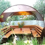 This is probably the simplest gazebo: two bent pipes that are fixed on the backs of garden benches. Polycarbonate is attached to the pipes. Summer garden gazebo is ready