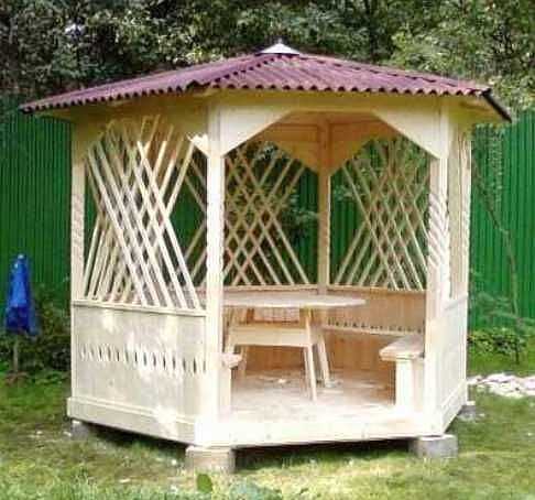 This is also a gazebo made of wood, but with a wooden floor. Therefore, it is raised on supports. The upper part is originally finished in it - the binding of processed thin boards looks great.