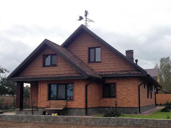 In this house, walls and gables are sheathed with basement siding, just different collections are used