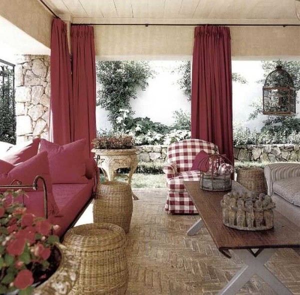 The open veranda is framed with curtains, but they are hidden behind columns