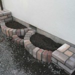 If the flowerbed is located near the wall, the wall must be treated with waterproofing (bituminous mastic twice)