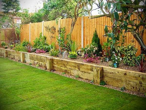 A high flower bed with a fence made of boards. The building is inexpensive and the view is solid