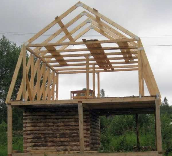 A small room made of logs below, and above - a vast attic, resting on racks