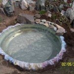 Water is poured, the film is finally smoothed, you can wrap the edges and press them with stones