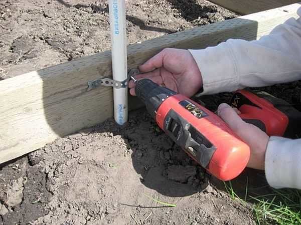 The pipe is attached to the base beam using a perforated metal tape
