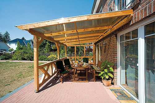 In this photo, an open veranda is attached to the house without a foundation - it is rather a summer shed