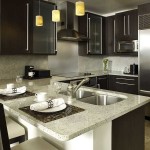 A small kitchen that goes into the living room is divided by such a wonderful table