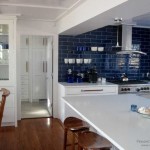 Dark blue tiles in a white kitchen - contrasting and unusual