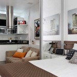 Glass and mirrored partitions often help out in small studio apartments: they allow you to create a separate room without dividing the space