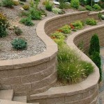 If the house and the plot are decorated in a simple style, then the retaining wall is trimmed with appropriate materials.