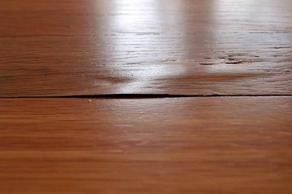 Such veneer flaking can most likely be eliminated simply by ironing it with an iron.
