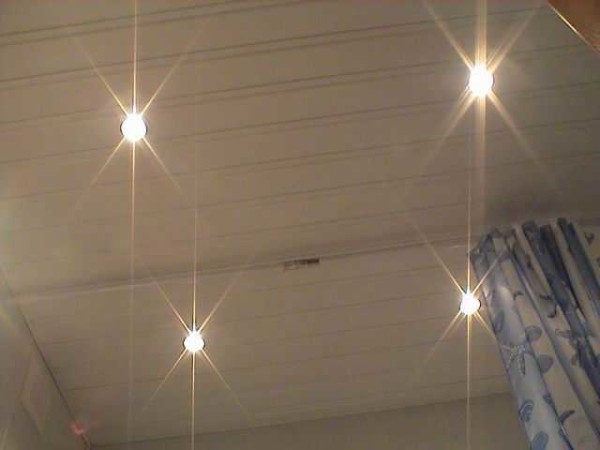 Four halogen bulbs on the plastic ceiling are powered by one transformer