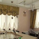 Double roman blinds up to the sill near the work area and with classic curtains of the same color near the large window