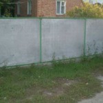 This slate fence is made with I-beam posts. Sheets are inserted into the frame and another U-shaped profile is welded on top