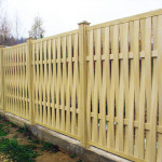 Another option for a fence made of boards curved between the supports, but this time the boards are placed vertically