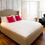 Barely noticeable drawing on the wall, but bright pillows on the bed