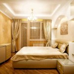 The bedroom is in a classic style, the wall opposite from the bed is pasted over with brighter wallpaper