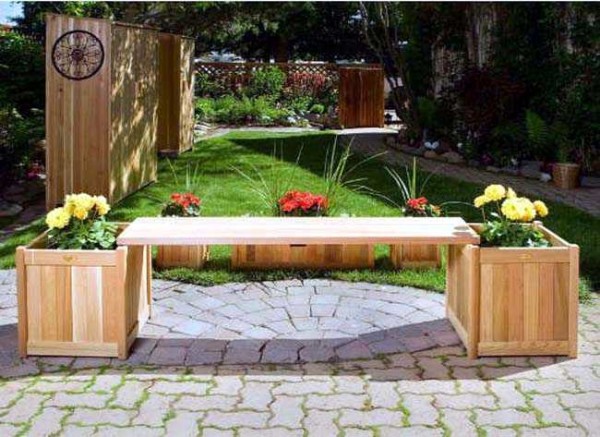 Two flower beds of their boards and between them a bench