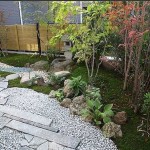 Plates, stones, rubble, plants - all this against the background of the lawn