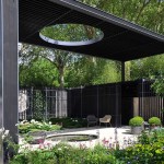Unusual gazebo: a roof with a hole illuminates a small pond. If desired, you can move the chairs in the shade or in the sun