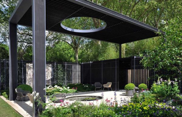 Unusual gazebo: a roof with a hole illuminates a small pond. If desired, you can move the chairs in the shade or in the sun