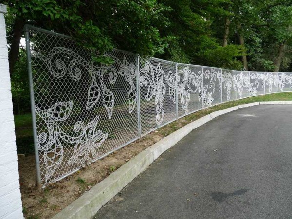 A decorated fence made of a chain-link mesh looks incredibly beautiful