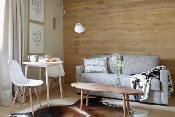 One wall is finished with wood or stone - one of the latest fashion trends