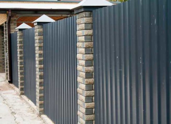 Decorative brick pillars decorate the fence