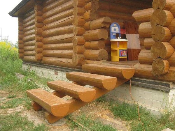 Porch to a wooden bath - a staircase made of logs