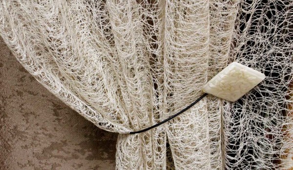 A type of mesh is a spider-web tulle. Looks great on the bedroom window