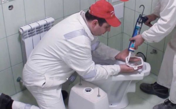 We coat the gasket with silicone, put it on the toilet