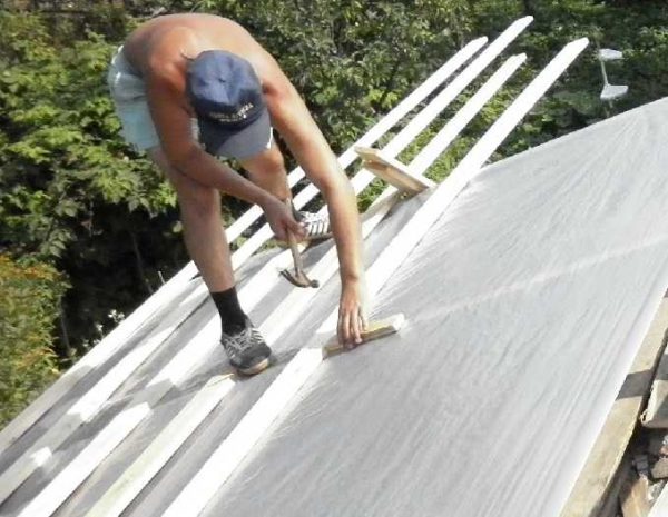The waterproofing membrane is laid over the rafter legs