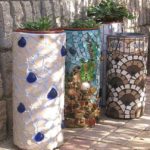 Finishing a concrete flowerpot with pieces of tiles