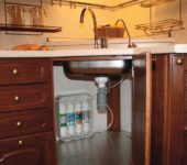 Water filters under the sink bring tap water to a drinking state