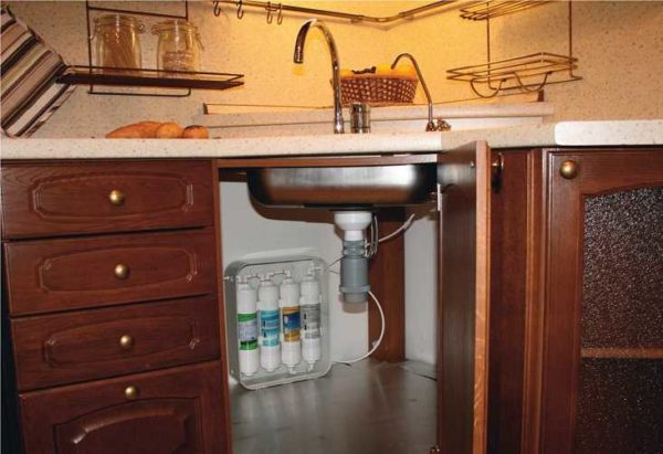 Water filters under the sink bring tap water to a drinking state