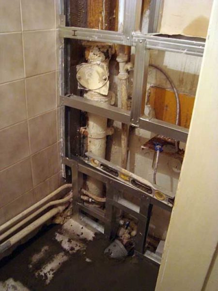 If the pipes are on the back wall, and the toilet is narrow and long, it makes sense to sew up the back wall completely