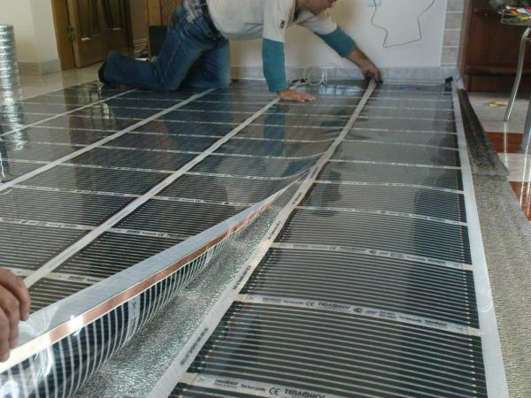 It is better to lay a laminate or linoleum floor with a film warm floor