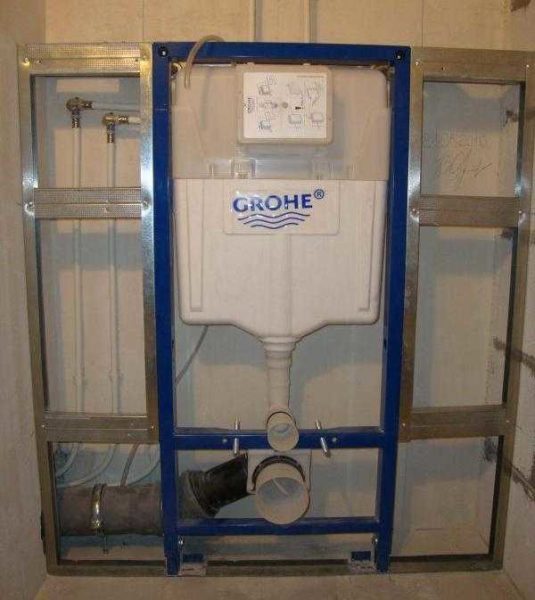 The frame installation for the toilet is built into the partition, but stands alone