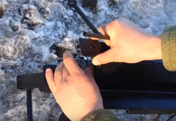 A spring is placed under the hole, then a bolt