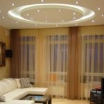 The center of this interior is a sofa, which is emphasized by the composition on the ceiling.
