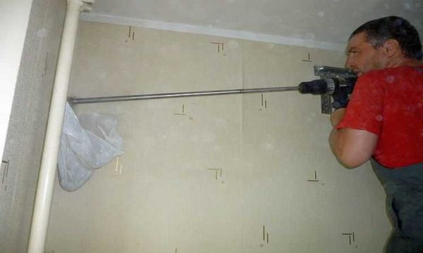 We drill a hole for the track to install the air conditioner with our own hands
