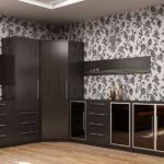 The highlight of this ensemble is unusual doors and an imbalance between the top and bottom of the furniture.