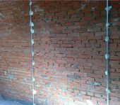 It looks like a wall with already installed lighthouses, ready for plaster